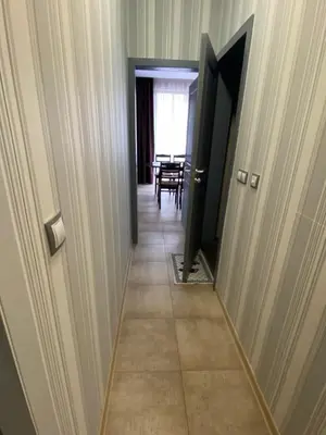 a hallway with a door leading to a dining room at Belchevi Apartments in Burgas City
