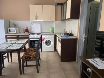 a kitchen with a washing machine and a dishwasher at Belchevi Apartments in Burgas City