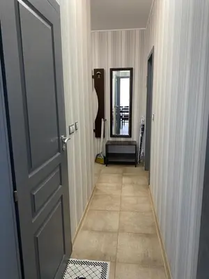 a hallway with a door and a mirror at Belchevi Apartments in Burgas City
