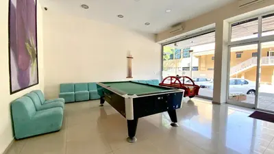 a living room with a pool table and a couch at Bratanov Asteria Family in Sunny Beach