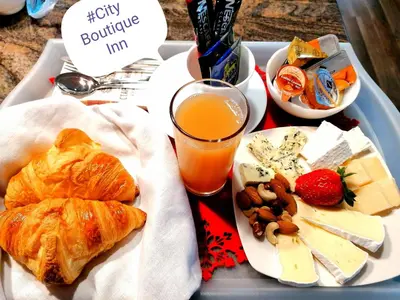 a tray with a tray of food and a drink at City Boutique Inn in Varna City
