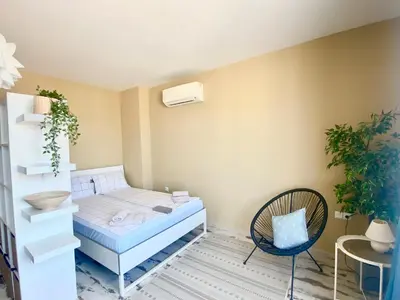 a bedroom with a bed and a chair at Apartments in Complex Sunny Island Deluxe in Chernomorets
