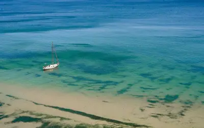 a boat sitting in the water on the beach at Ecoclub in Varna City