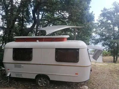 a white camper with a surfboard on top of it at Ecoclub in Varna City