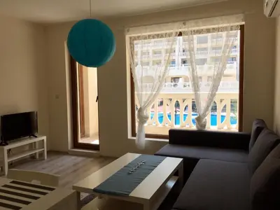 a living room with a couch and a large window at PSB Apartments in South Bay Varna in Varna City