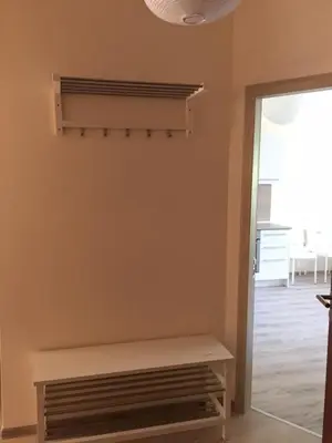 a room with a bench next to a door at PSB Apartments in South Bay Varna in Varna City