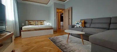 a living room with a couch and a bed at Black Sea View - Luxory apartment by the sea in Burgas City