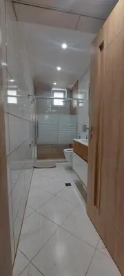a large bathroom with a toilet and a sink at Black Sea View - Luxory apartment by the sea in Burgas City