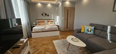 a living room with a couch and a bed at Black Sea View - Luxory apartment by the sea in Burgas City