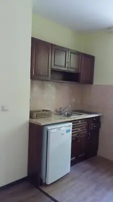 a kitchen with a white refrigerator and wooden cabinets at к-г Луна к-с Лонгоза комплекс Лонгоза in Byala
