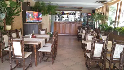 a restaurant with tables and chairs and a bar at Hotel Morska Zvezda in Sozopol