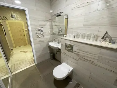 a bathroom with a toilet and a sink and a shower at De Luxe Studio Burgas, City Center in Burgas City