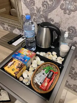 a table with a tray of food and a kettle at De Luxe Studio Burgas, City Center in Burgas City