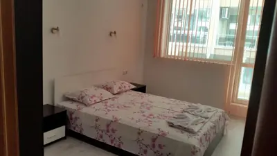 a small bedroom with a bed and a window at Apartamenti Eli in Pomorie