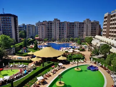 a view of a resort with a pool and tables and chairs at Apartment in Hotel Royal Beach 5 Pool View in Sunny Beach