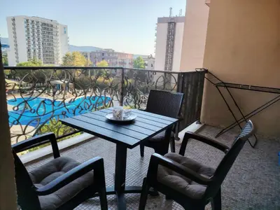 a table and chairs on a balcony with a view at Apartment in Hotel Royal Beach 5 Pool View in Sunny Beach