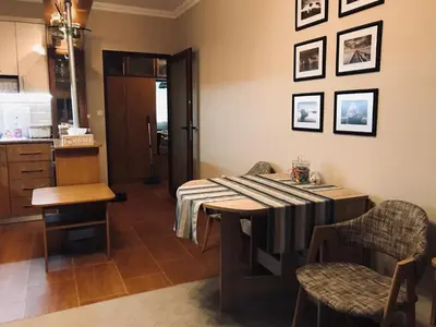 a dining room with a table and chairs at Apartament Odesos in Varna City