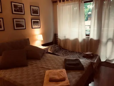 a bedroom with a bed and a window at Apartament Odesos in Varna City