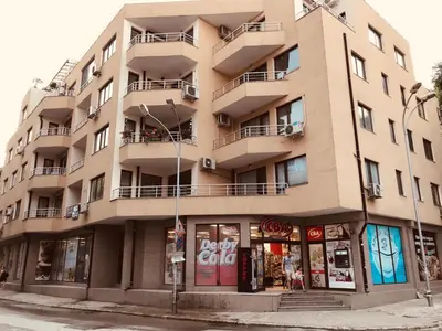 an apartment building on the corner of a street at Apartament Odesos in Varna City