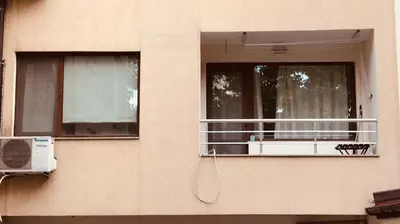 a building with a balcony with a air conditioner at Apartament Odesos in Varna City