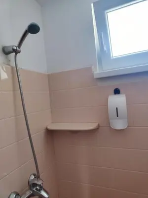 a shower in a bathroom with a window at Jacky's House in Chernomorets