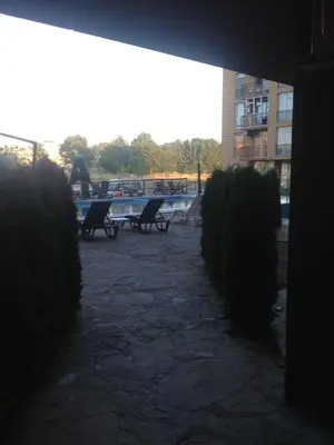 a group of benches in a courtyard with bushes at Sanny view South- Студия Мир авангарда in Sunny Beach