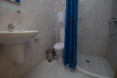 a bathroom with a sink and a toilet and a shower at Family Hotel Orios in Primorsko