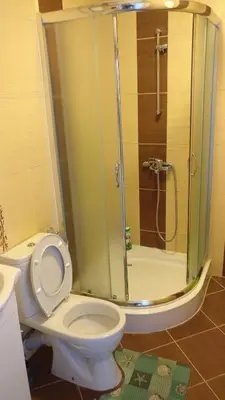 a bathroom with a toilet and a glass shower at Club Priz in Primorsko