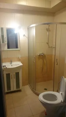 a bathroom with a shower and a toilet and a sink at Club Priz in Primorsko
