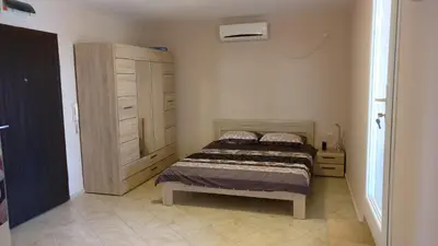 a small bedroom with a bed and a cabinet at Club Priz in Primorsko