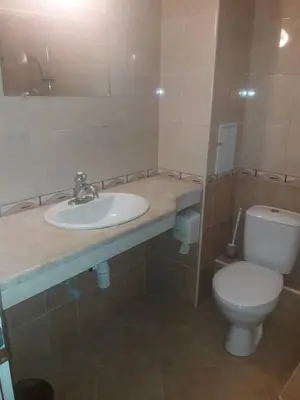 a bathroom with a sink and a toilet at Hotel Black Sea - Breakfast, Pool & Free Parking in Obzor