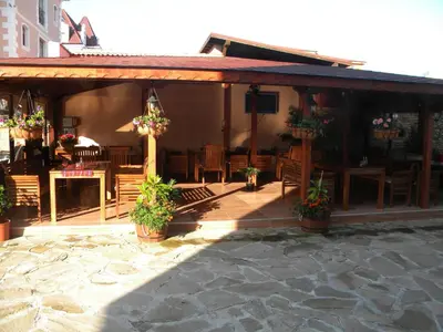 a pavilion with chairs and tables and plants at Hotel Black Sea - Breakfast, Pool & Free Parking in Obzor