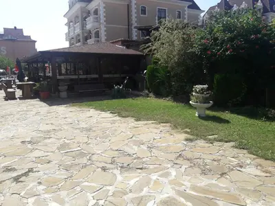 a stone walk way with a building in the background at Hotel Black Sea - Breakfast, Pool & Free Parking in Obzor