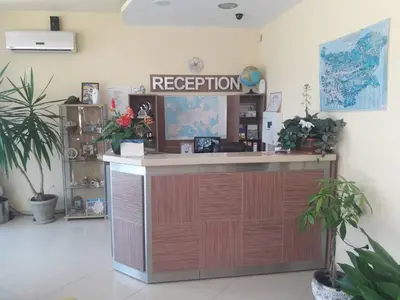 a reception desk in a room with potted plants at Hotel Black Sea - Breakfast, Pool & Free Parking in Obzor