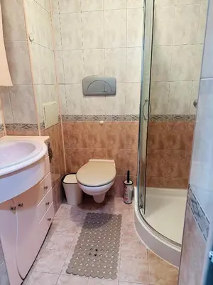 a small bathroom with a toilet and a shower at Lux Apartment Sisi in Burgas City