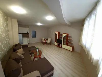 a living room with a couch and a table at Lux Apartment Sisi in Burgas City