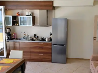 a kitchen with a stainless steel refrigerator at AKB Apartment Sea View in Aheloy