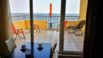a view of a balcony with a table and chairs at AKB Apartment Sea View in Aheloy