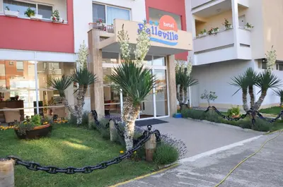 a building with palm trees in front of it at Hotel BelleVille in Sunny Beach