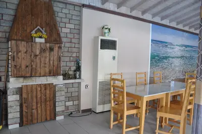 a kitchen with a table and chairs and a refrigerator at Hotel BelleVille in Sunny Beach