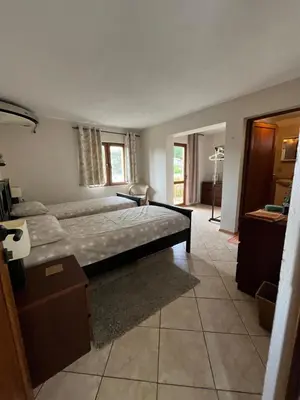 a bedroom with a large bed in a room at Villa Tunley in Razvalini Balchikioy