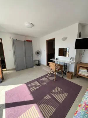 a living room with a purple rug and a piano at Villa Tunley in Razvalini Balchikioy