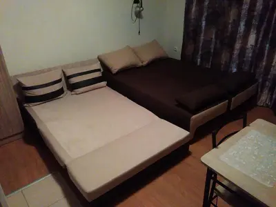 a small living room with a black and white couch at Galata in Varna City