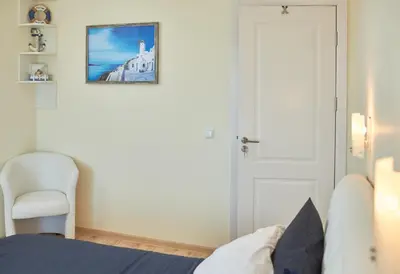 a bedroom with a bed and a white door at Morning Star Deluxe in Chernomorets