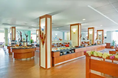 a restaurant with a buffet of food on display at Hotel Perla Beach Club - All Inclusive in Primorsko