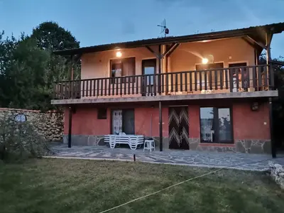 a large house with a balcony and a table at Sunset House in Varna City