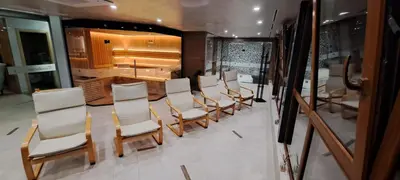 a group of chairs and a table in a room at Paradise Hotel & Relax Center in Pomorie