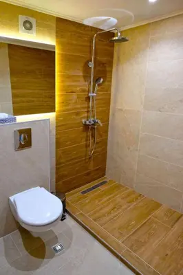 a bathroom with a shower with a toilet and a shower at Paradise Hotel & Relax Center in Pomorie
