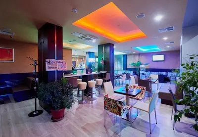 a restaurant with a dining room with tables and chairs at Paradise Hotel & Relax Center in Pomorie
