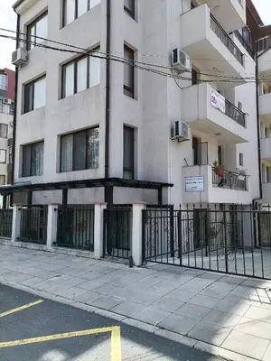 a building with a fence in front of it at White home-apartament in Burgas City